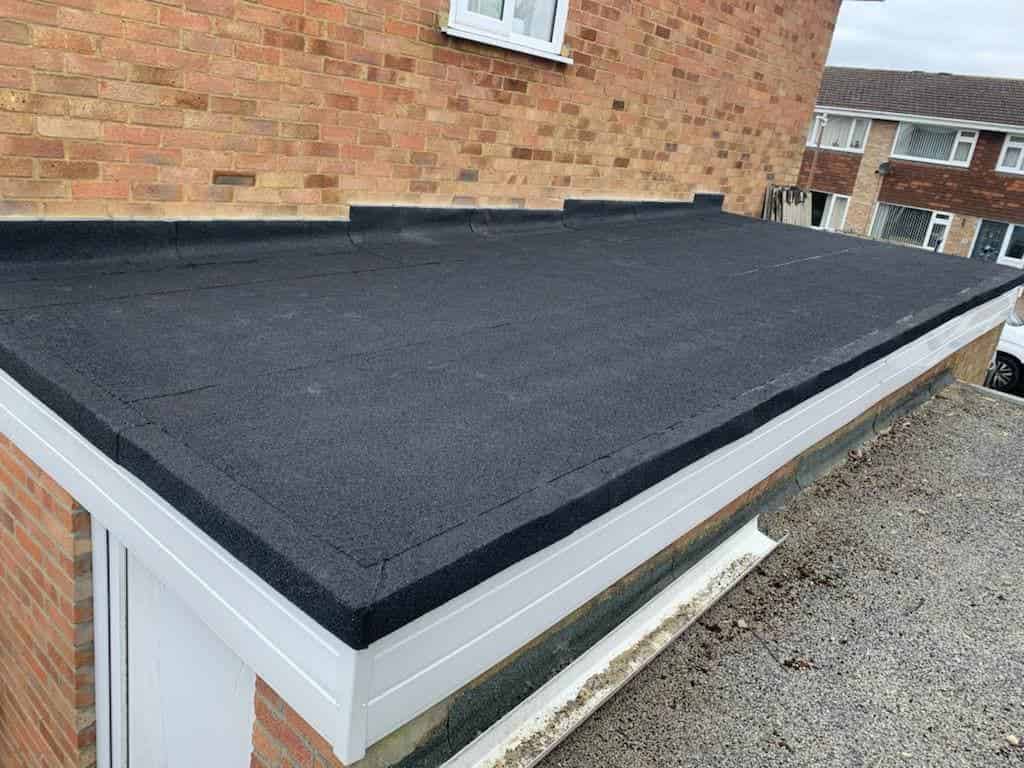 This is a photo of a newly installed flat roof, it has been installed onto the top of a garage, and is single ply roofing