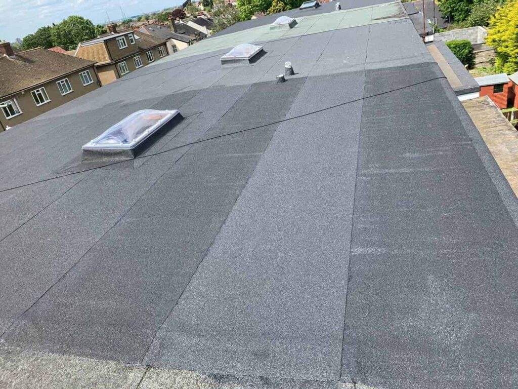 This is a photo of a commercial flat roof. It is a large roof with skylights installed too.