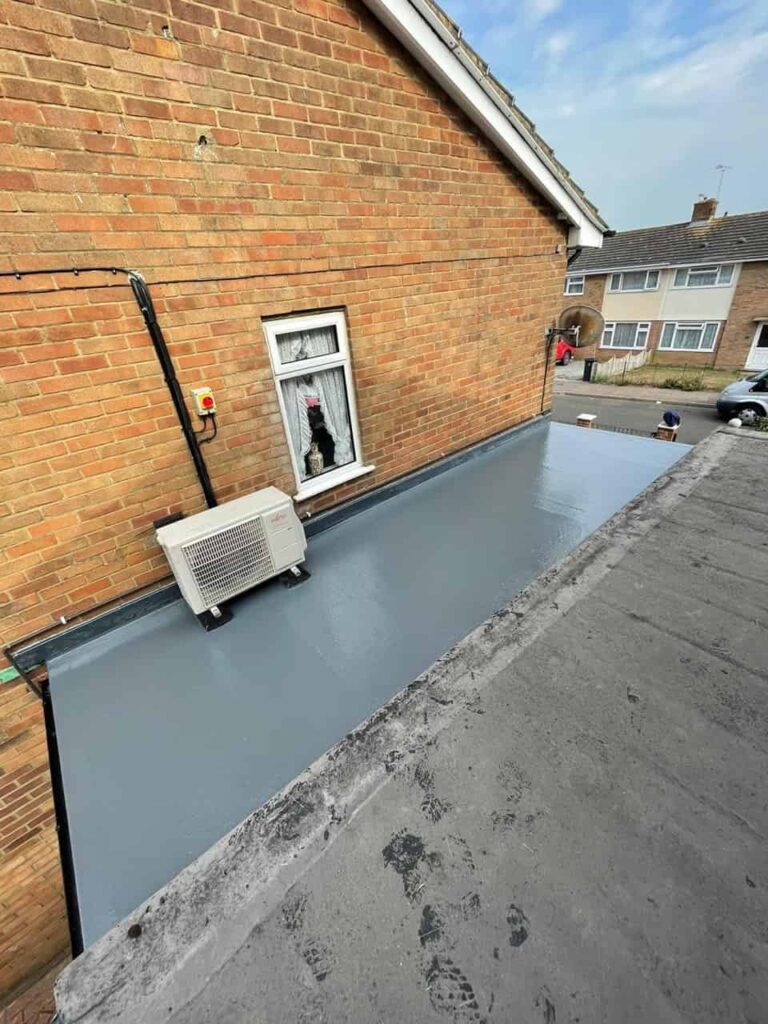 This is a photo of a newly installed liquid flat roof which has been completed to a very high standard and finished in grey colour. It is installed on a porch roof.