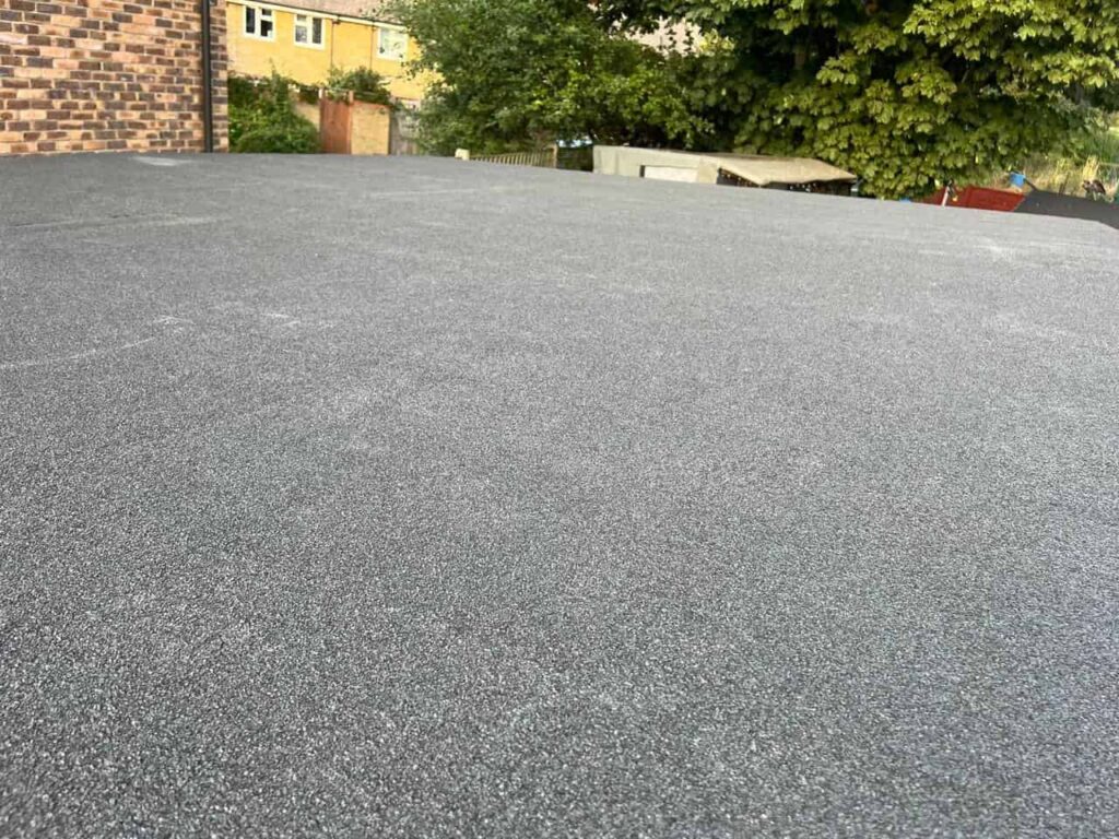 This is a photo of a large flat roof that has been installed on top of an extension.
