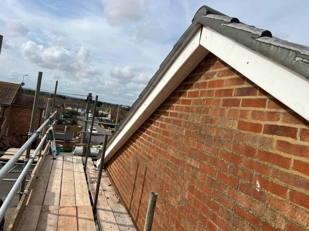 This is a photo of the gable end of a roof with newly installed roof tiles, and it also shows the new facias and soffits.