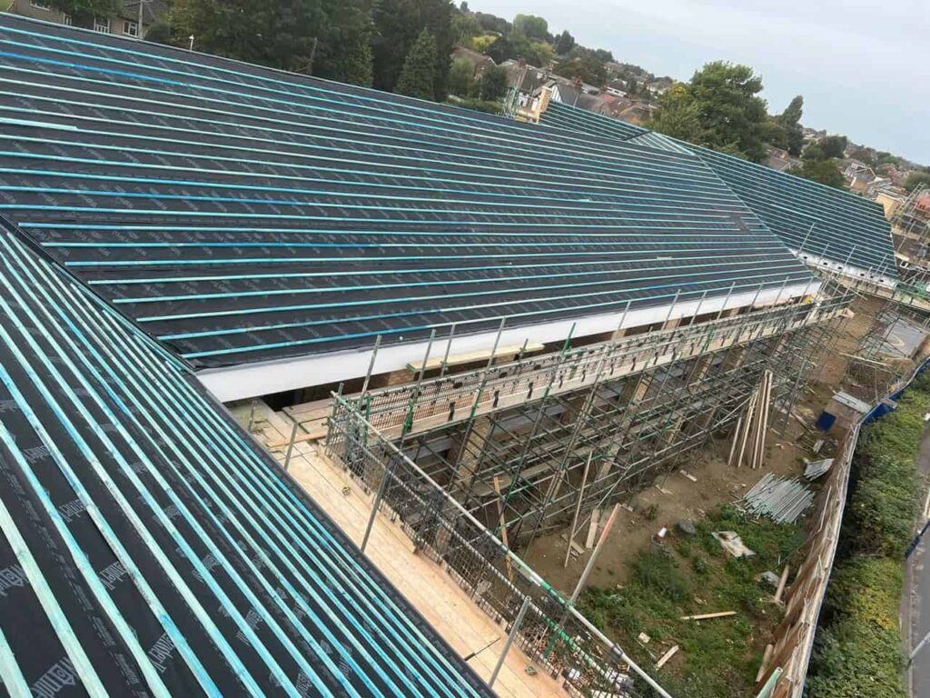 This is a photo of a newly constructed roof which has been felt and battened, and is now waiting for the new tiles to be installed. The photo has been taken from the roof.